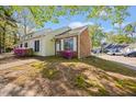 Charming home exterior with a brick facade, neutral siding and tidy landscaping at 42 Riverwalk Ter, Durham, NC 27704