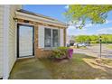 Inviting front entrance with brick and well maintained lawn and mature landscaping at 42 Riverwalk Ter, Durham, NC 27704