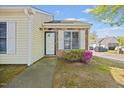 Inviting front entrance with brick and well maintained lawn and mature landscaping at 42 Riverwalk Ter, Durham, NC 27704