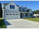 Charming home featuring a two-car garage and manicured lawn at 427 Earnest Way # L24, Kenly, NC 27542