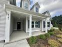 Inviting front porch with classic columns, complemented by fresh landscaping at 427 Earnest Way # L24, Kenly, NC 27542