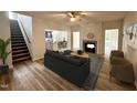 Beautifully staged living room with fireplace, hardwood floors and staircase at 427 Earnest Way # L24, Kenly, NC 27542