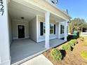 Welcoming front porch with classic white columns and stylish landscaping at 427 Earnest Way # L24, Kenly, NC 27542