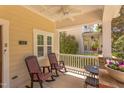 Relaxing front porch with rocking chairs, ceiling fan, and space for a small dining table at 43 Turtle Point Bnd, Chapel Hill, NC 27516