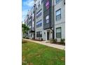 Stylish townhome featuring modern design with gray brick and sleek black accents at 433 Wait Ave # 100, Wake Forest, NC 27587