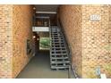 Stairwell to upper units showcases brick walls and unit number at 4507 Edwards Mill Rd # F, Raleigh, NC 27612