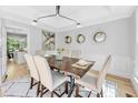 Elegant dining room with hardwood floors, stylish lighting, and seating for six at 510 Guy Walker Way, Durham, NC 27703