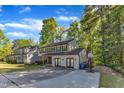 Inviting two-story residence with a spacious driveway, complemented by mature trees and a well-kept lawn at 5315 Oakbrook Dr, Durham, NC 27713