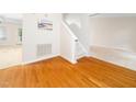Bright entrance featuring gleaming hardwood floors, stairs, and access to other rooms at 5504 Cumberland Plain Dr, Raleigh, NC 27616