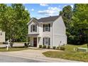 Well-maintained two-story home featuring a tidy lawn and driveway, enhanced by mature trees and leafy bushes at 5801 Forest Point Rd, Raleigh, NC 27610