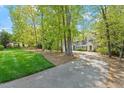 Picturesque home surrounded by lush greenery and mature trees, offering privacy and curb appeal at 605 Glen Eden Dr, Raleigh, NC 27612