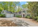 Inviting home with a two-car garage, well-maintained landscaping, and classic architectural details at 605 Glen Eden Dr, Raleigh, NC 27612