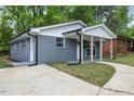 This home's exterior has a gray brick facade, white trim, and well-maintained landscaping at 606 Cecil Street St, Durham, NC 27707