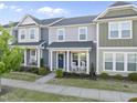 Inviting townhouse front view featuring a cozy porch with rocking chairs and neat landscaping at 6511 Academic Ave, Raleigh, NC 27616
