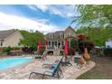 Beautiful backyard featuring a pool, outdoor seating, and landscaped surroundings, perfect for relaxation at 6512 Southern Times Dr, Raleigh, NC 27603