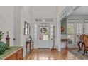 Bright foyer with hardwood floors, white trim, and transom windows offers a welcoming entrance at 6512 Southern Times Dr, Raleigh, NC 27603