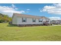 Single-story home features a landscaped yard and welcoming entryway at 7228 Lowery Meadow Dr, Wendell, NC 27591