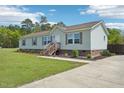 Single-story home featuring a landscaped yard, concrete driveway, and welcoming entryway at 7228 Lowery Meadow Dr, Wendell, NC 27591