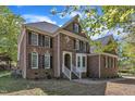 A stately brick home with beautiful architectural features and a well-kept yard at 8022 Hogan Dr, Wake Forest, NC 27587