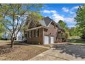 Spacious home with a two-car garage, rear balcony, and lush surrounding landscape at 8022 Hogan Dr, Wake Forest, NC 27587