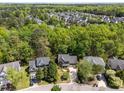 Aerial view of a neighborhood showcasing the property, surrounding trees, and community at 8212 Duck Creek Dr, Raleigh, NC 27616