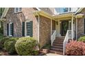Close-up showcasing brick detail, front door, and landscaped entryway at 903 Oldwyck Dr, Fuquay Varina, NC 27526