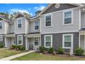 View of townhome with well-kept lawn, tasteful landscaping and walkway to front door at 918 E Green St # F105, Franklinton, NC 27525