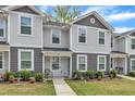 Inviting gray and white townhome with a well-kept lawn and sidewalk leading to the front door at 918 E Green St # F105, Franklinton, NC 27525