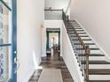 Bright and welcoming foyer with hardwood floors, staircase, and views into the adjacent dining room at 937 Matterhorn Dr, Fuquay Varina, NC 27526