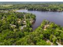 High angle aerial view of the lakefront property and lush green surroundings at 959 Sagamore Dr, Louisburg, NC 27549