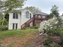 Rear exterior with a deck and stairs in a well-maintained backyard with flowers at 959 Sagamore Dr, Louisburg, NC 27549