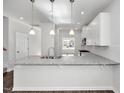 Spacious kitchen showcasing granite countertops, white cabinetry, and stainless steel appliances creating a modern space at 4868 Pioneer Dr, Sanford, NC 27330