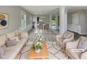 Bright, open living room with neutral tones, elegant decor, and a view into the dining area at 10 Sandy Bluff Ct, Durham, NC 27703