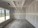 Bedroom featuring a coffered ceiling and large windows providing natural light at 1000 Peedin Rd, Selma, NC 27576