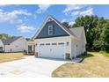 Attached two-car garage with modern doors, lighting, and extended driveway at 1000 Peedin Rd, Selma, NC 27576