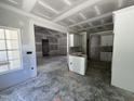 Spacious interior view revealing a kitchen area with bright white cabinetry and an open layout at 1000 Peedin Rd, Selma, NC 27576