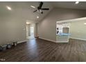 Bright open-concept living room with hardwood floors, vaulted ceiling, and access to the kitchen at 1000 Peedin Rd, Selma, NC 27576