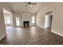 Open living room with high ceilings, a fireplace, wood floors, and natural light at 1000 Peedin Rd, Selma, NC 27576