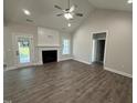 Cozy living room featuring hardwood floors, a fireplace, and a view of the outdoors at 1000 Peedin Rd, Selma, NC 27576