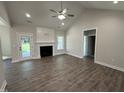 Cozy living room with vaulted ceiling, a fireplace, recessed lights, and beautiful flooring at 1000 Peedin Rd, Selma, NC 27576
