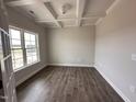 Bright office space featuring coffered ceilings, dark hardwood floors, and a large window at 1000 Peedin Rd, Selma, NC 27576