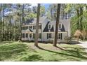 Elegant two-story home with a well-kept lawn, showcasing its classic design and inviting curb appeal at 1013 Whitney Springs Ct, Holly Springs, NC 27540