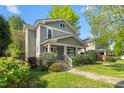 Charming two-story home with a welcoming front porch and well-maintained landscaping on a sunny day at 104 E Wilson St, Mebane, NC 27302