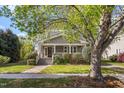 Charming two-story home with a welcoming front porch and well-maintained landscaping at 104 E Wilson St, Mebane, NC 27302