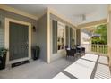 Inviting front porch with neutral paint and ceiling fan at 1093 Trentini Ave, Wake Forest, NC 27587