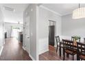 Bright dining area featuring hardwood floors, chair rail detail, and an elegant dining set at 11210 Lofty Heights Pl, Raleigh, NC 27614
