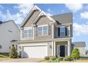 Beautiful two-story house featuring a two-car garage, black door, and well-kept landscaping at 12 Douglas Fir Pl, Clayton, NC 27520