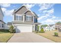 Inviting two-story home with a spacious driveway and well-manicured lawn at 12 Douglas Fir Pl, Clayton, NC 27520