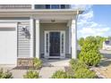 Inviting front porch with stone accents and a black front door at 12 Douglas Fir Pl, Clayton, NC 27520