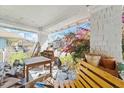 View of a cluttered porch filled with discarded furniture and miscellaneous items at 1207 Wall St, Durham, NC 27701